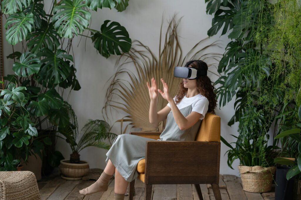 Young excited woman wearing VR glasses buying garden tools for home gardening in virtual reality